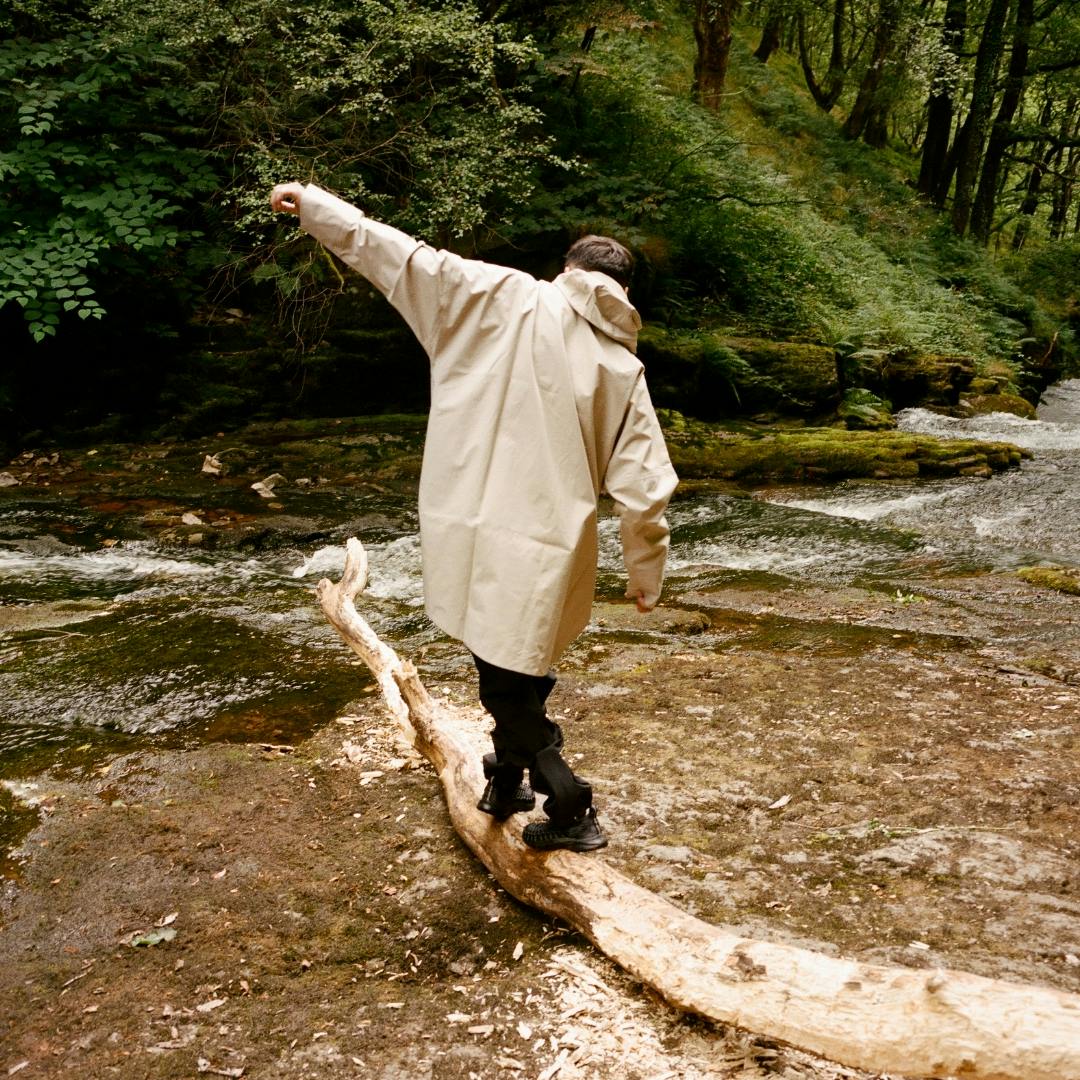 Person exploring the outdoors wearing a shell poncho from BLÆST