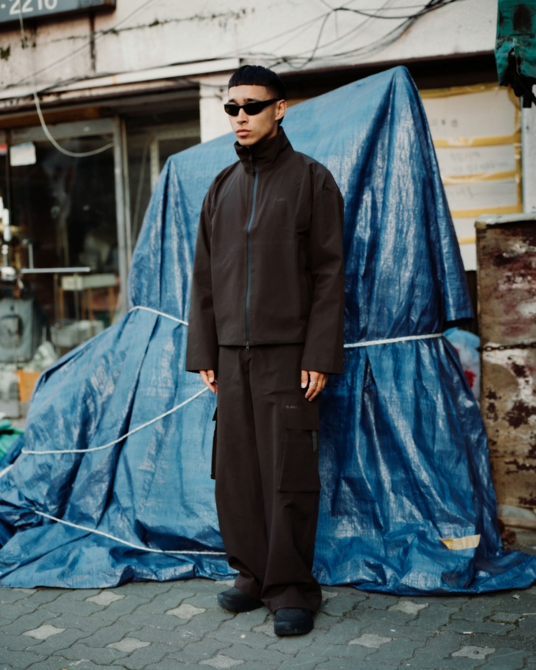 Man wearing the Sula jacket and Klipra pant from BLÆST while exploring Seoul