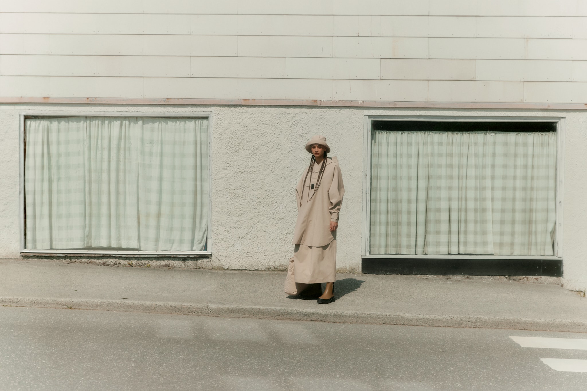 Woman wearing Bergen poncho from BLÆST in beige