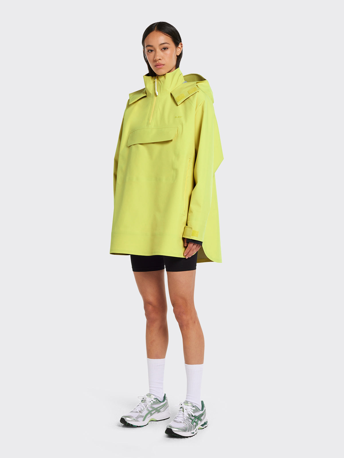 Woman wearing Voss poncho in the color Muted Lime by Blæst