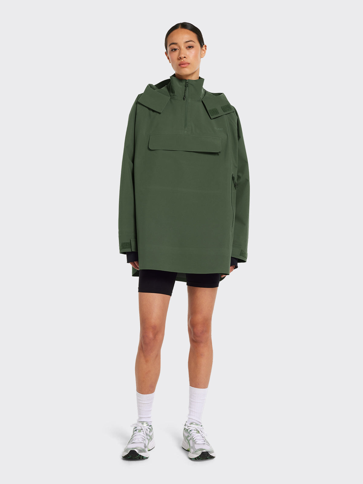 Woman wearing Voss poncho in Dusty Green from Blæst