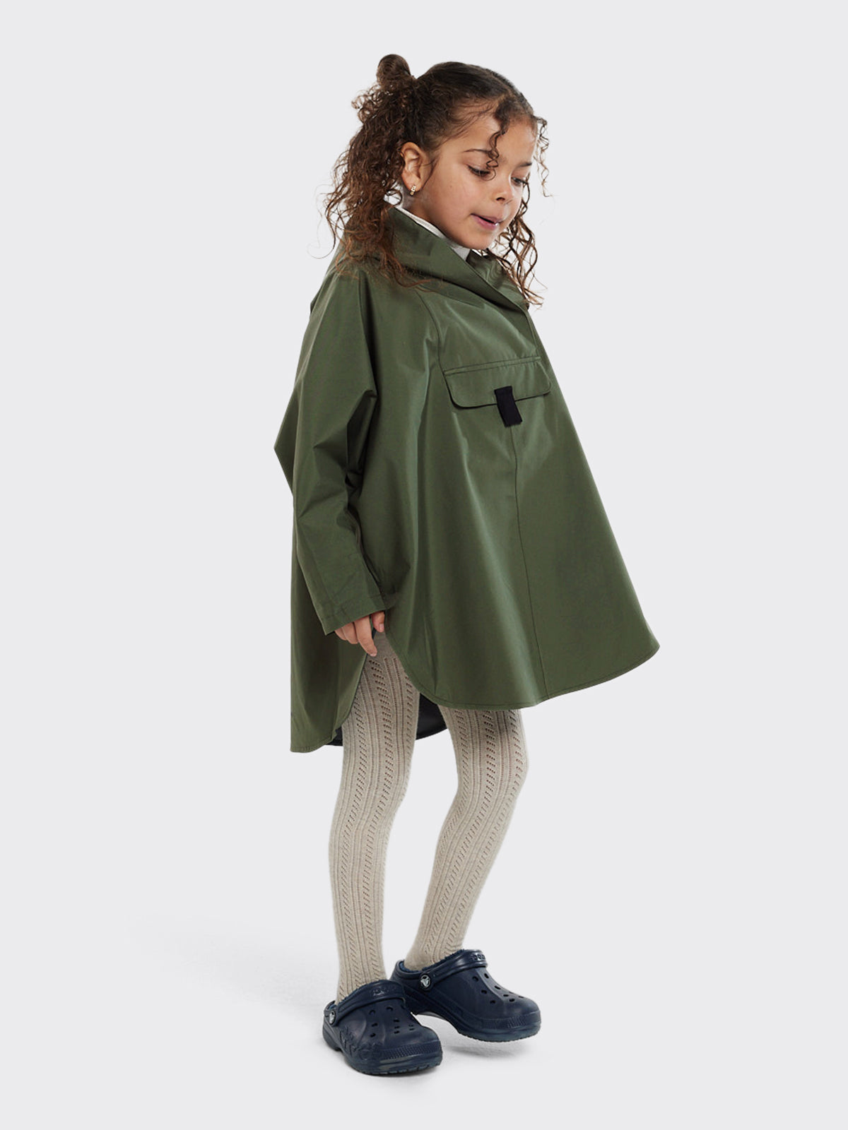 Kid wearing Bergen mini poncho by Blæst in the color Dusty Green